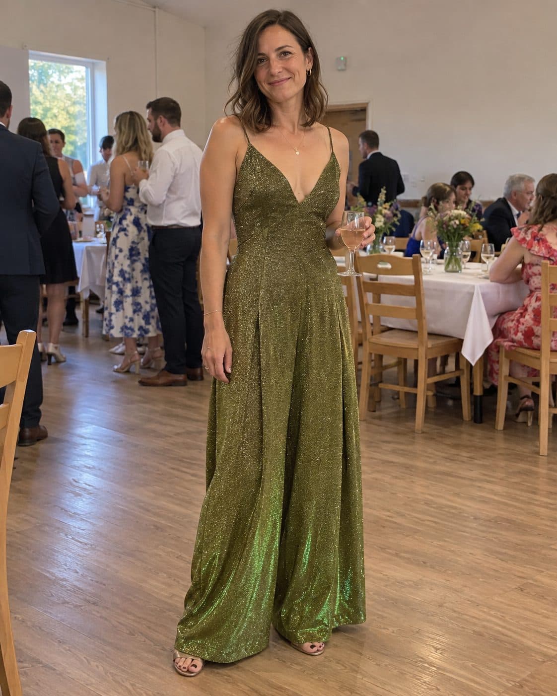 Mise en scène générée de la combinaison dorée portée par une invitée dans une réception de mariage simple